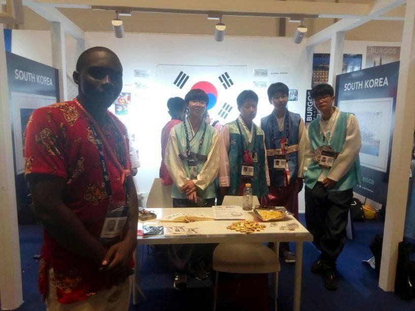 Standing with the South Korean delegation at their exhibit stand.