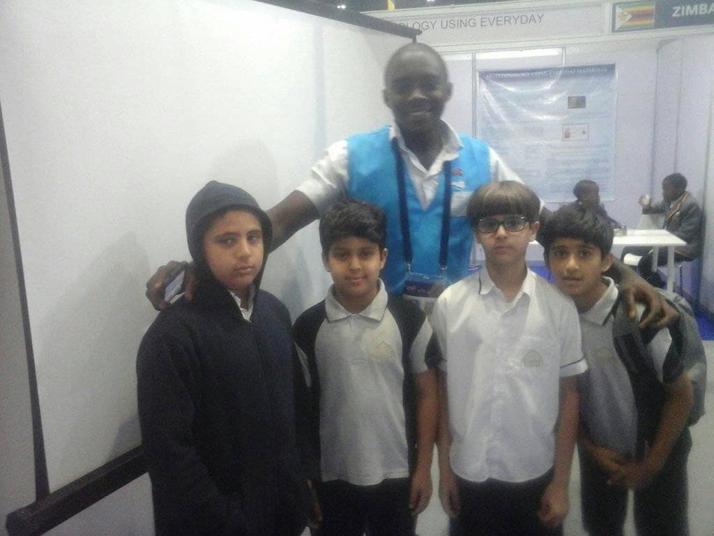 Presenting the exhibit to a group of visiting schoolchildren on the exhibition floor.